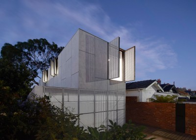 House Cladded With Cement Panels And Perforated Shutters
