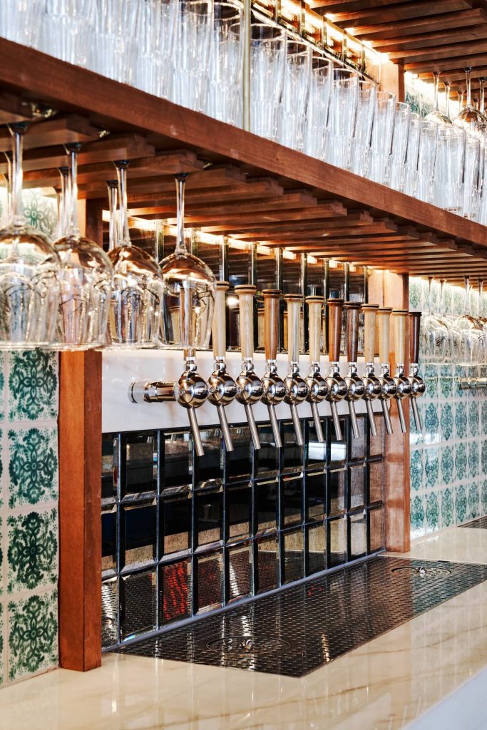 beer taps and marble counters 683x1024 Craft Brewery Built in a Century old Brick Building