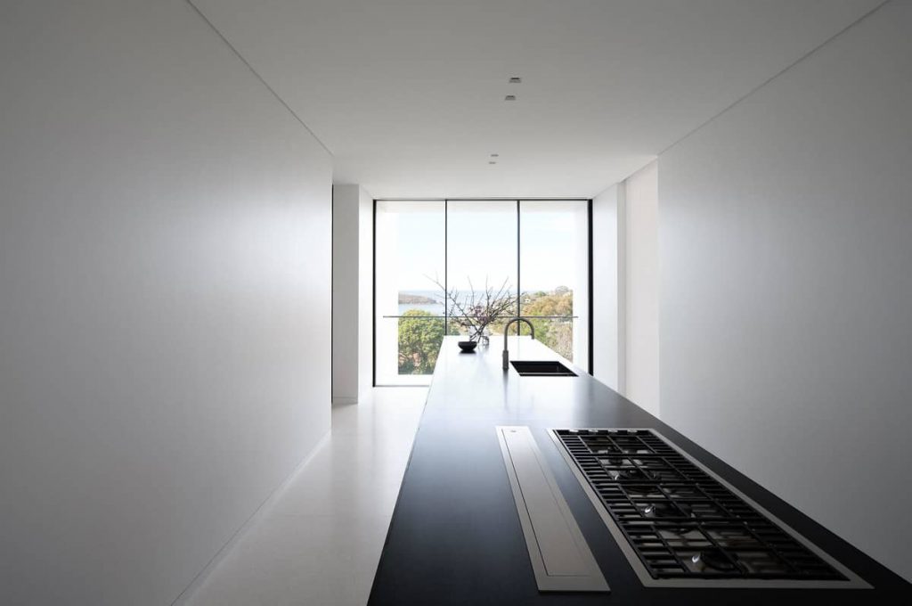 central elongated kitchen island bench 1024x680 A House Designed Around the Sculptural Form Of a Large Angophora Tree