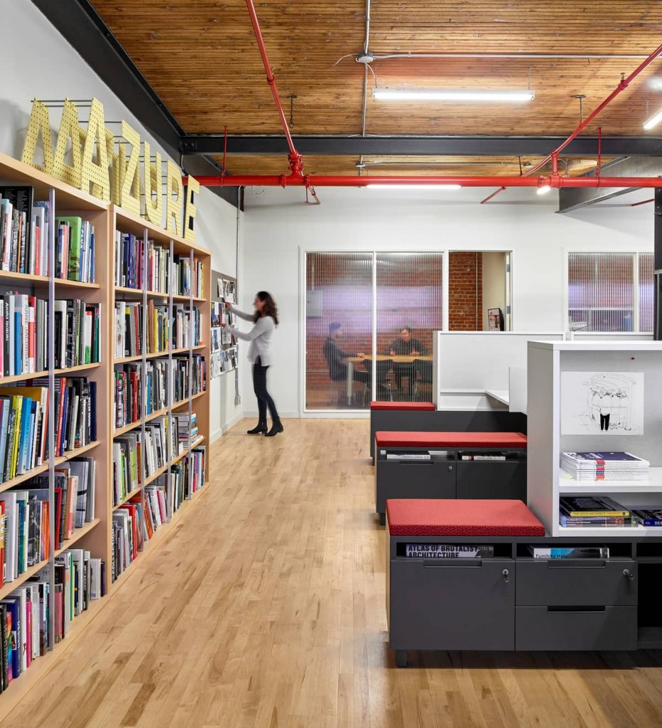 integrated bookshelves and storage cubbies 932x1024 An Old Transformer Factory Was Converted into a Bright Office