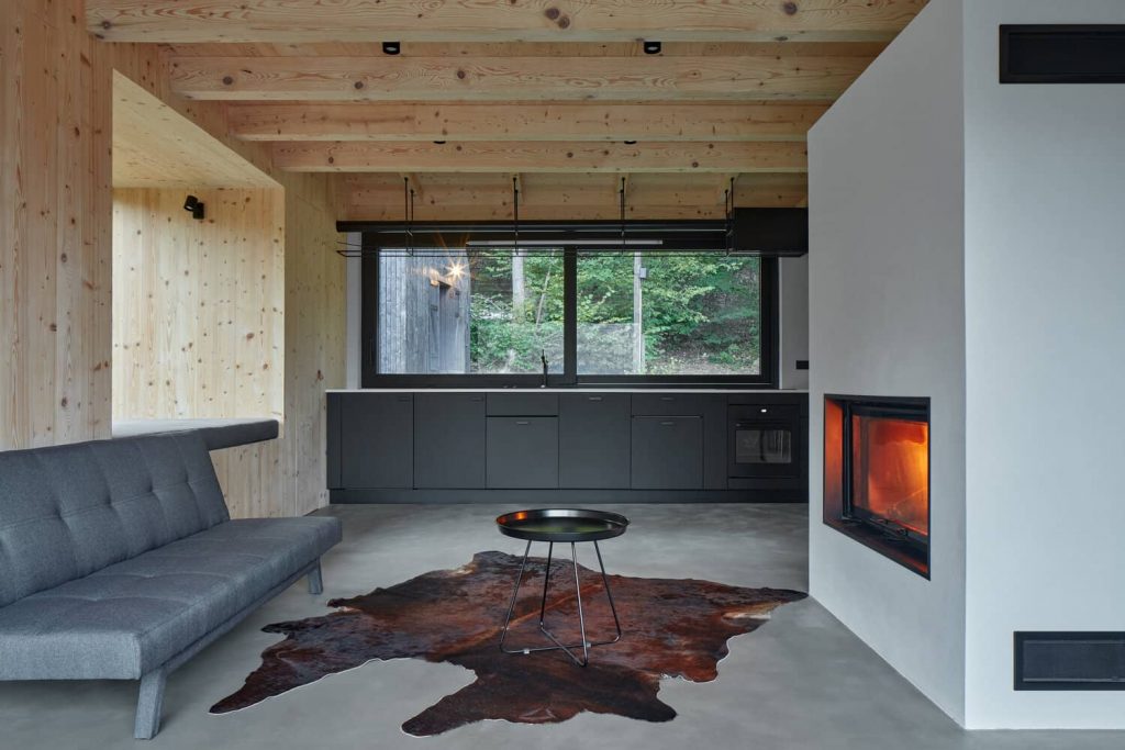 kitchen and fireplace 1024x683 A Cozy Cottage in the Woods by MjöLK Architects