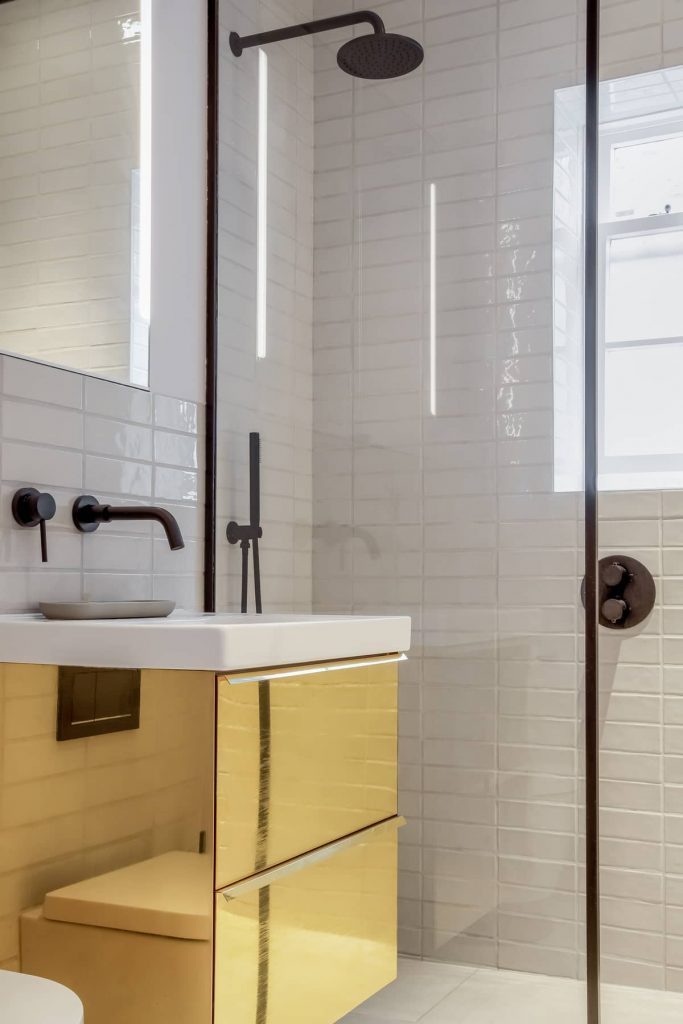 Under-sink unit claded in polished brass