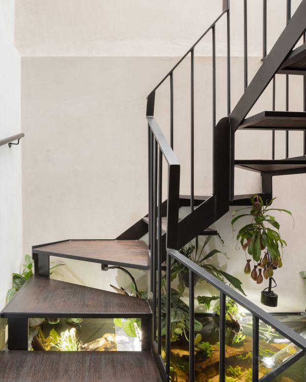 a curling steel stair Unagru Architects Transformed a Traditional Terrace Into a Bright Home