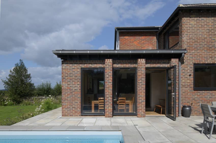 an open connection to patio and pool A Complete Renovation and Extension of a 1960’s House by CAIRN