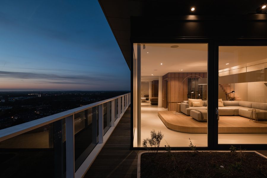 evening views Bureau Fraai Added Free Standing Oak Volumes to This Luxurious Penthouse