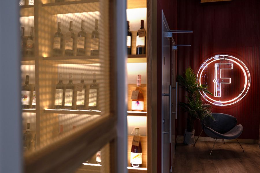 wine bottles and neon sign A Cheese Inspired Restaurant in Poznań by 370studio